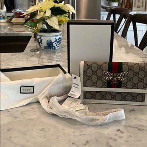 Gucci crossbody with rhinestone butterfly.